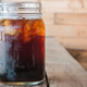 A cup of iced coffee on a wooden table